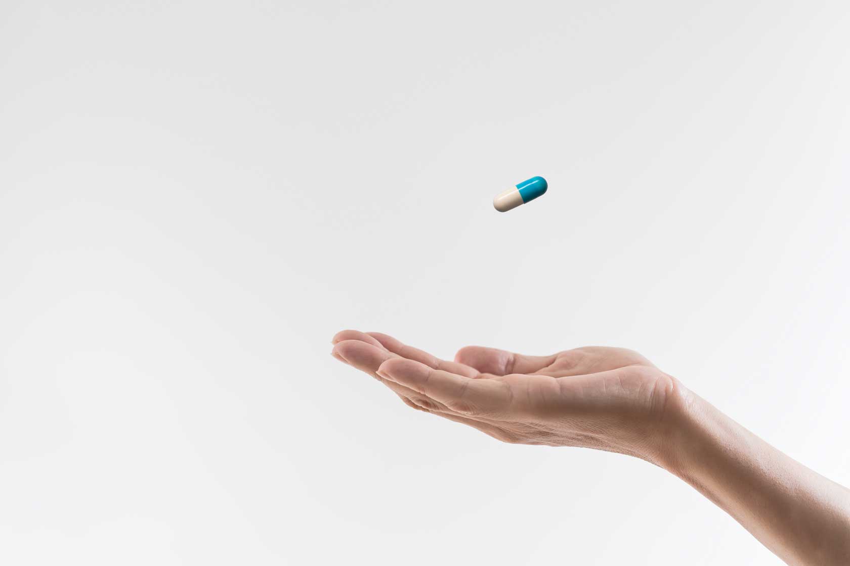 Hand with a pill | How Do Medications Affect My Oral Health?