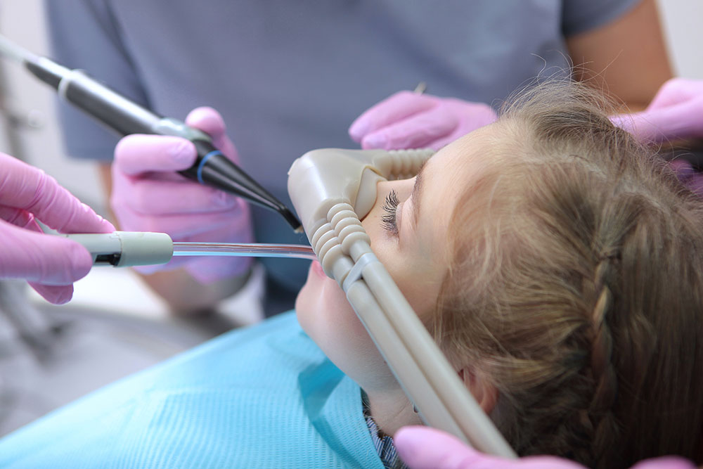 Child receiving sedation dentistry during a dental procedure for the article 'What Are the Benefits of Sedation Dentistry?