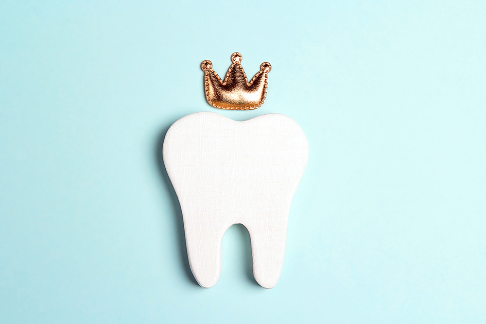 Illustration of a tooth with a crown for the blog article titled 'Why Do I Need a Dental Crown?